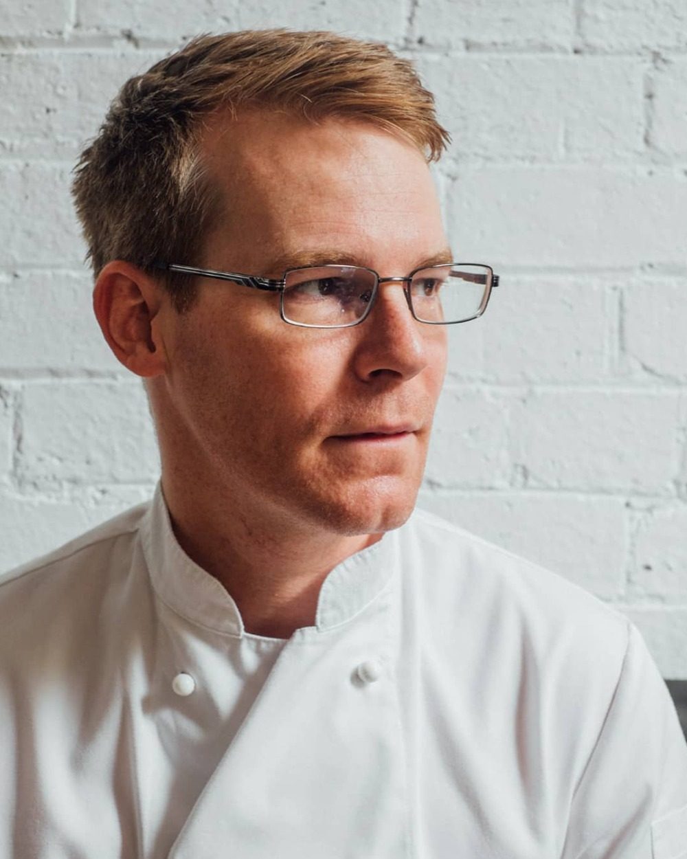 Me in chef’s whites, looking off to one side.